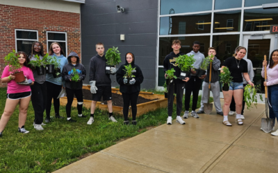 students with native pollinator garden